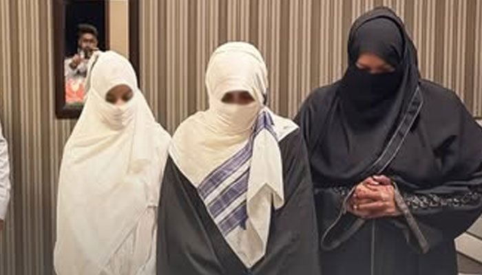 Three veiled women at Karachi airport during FIA immigration action